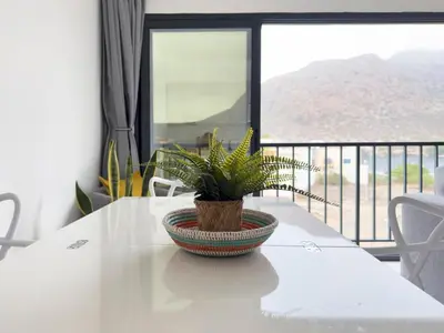 a plant in a bowl on a table with a balcony at Cozy apt amazing seaview - 2 min from beach - LCGR in Tarrafal