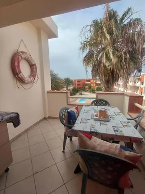 a dining room with a table and chairs on a balcony at Casa Mendonça in Santa Maria