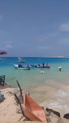 a group of boats in the water on a beach at Casa Mendonça in Santa Maria