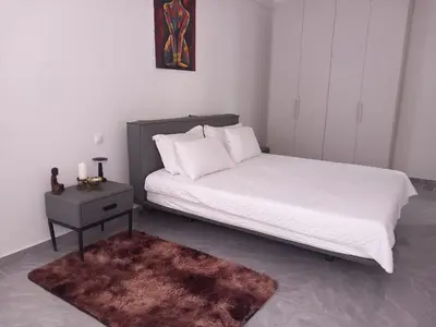 a bedroom with a bed and a nightstand with a white bedspread at Sal Rei ,Boavista Magic Apartment - in Sal Rei