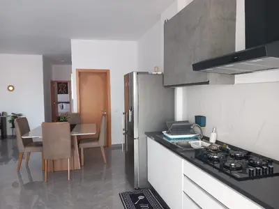 a kitchen with a stove top oven next to a table at Sal Rei ,Boavista Magic Apartment - in Sal Rei