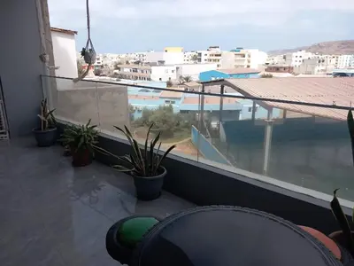 a balcony with plants and a view of a city at Sal Rei ,Boavista Magic Apartment - in Sal Rei