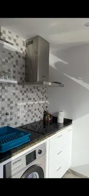 a kitchen with a washing machine in a kitchen at Ponta do Sol 