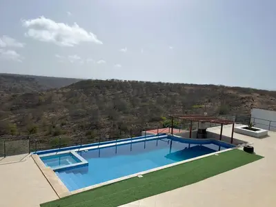 a swimming pool with a view of a mountain at Ponta de mar in Praia