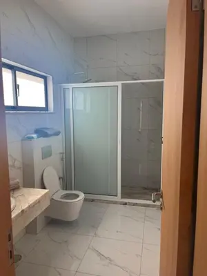 a bathroom with a glass shower and a toilet at Ponta de mar in Praia