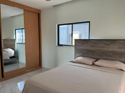 a bedroom with a bed and a large mirror at Ponta de mar in Praia