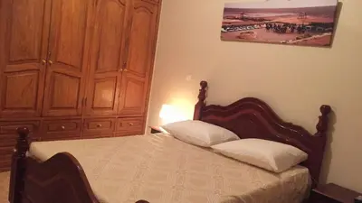 a bedroom with a bed and a wooden cabinet at Comfortable private room in Assomada in Assomada