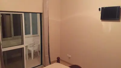 a bathroom with a mirror and a tv on the wall at Comfortable private room in Assomada in Assomada