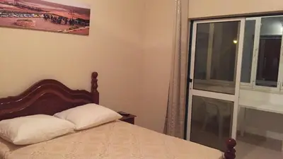 a bedroom with a bed and a sliding glass door at Comfortable private room in Assomada in Assomada