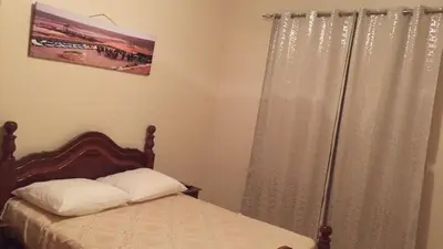 a bedroom with a bed and a window with curtains at Comfortable private room in Assomada in Assomada