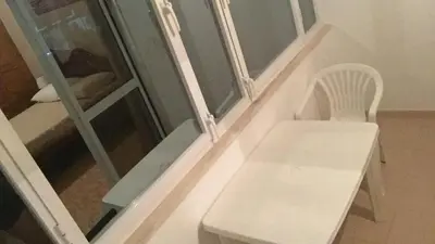 a white bench sitting in front of a window at Comfortable private room in Assomada in Assomada
