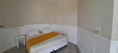a small white room with a bed in it at Bungalow Praia de Chaves Sol & Mar in Cabeçadas