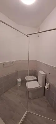 a bathroom with a toilet and a sink at Bungalow Praia de Chaves Sol & Mar in Cabeçadas