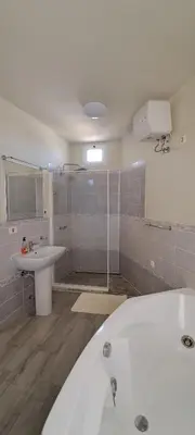 a bathroom with a bath tub and a sink at Bungalow Praia de Chaves Sol & Mar in Cabeçadas