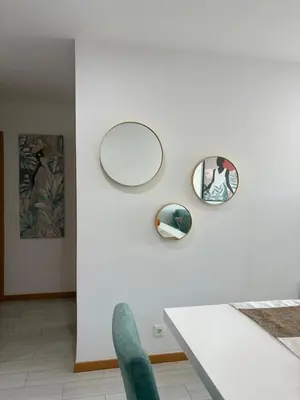 two mirrors on a white wall in a room at Santa Maria Residence - Central T2 in Santa Maria