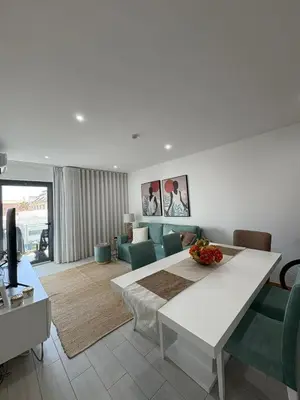 a living room with a table and some chairs and a couch at Santa Maria Residence - Central T2 in Santa Maria
