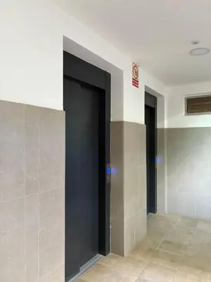 a hallway with two elevator doors in a building at Santa Maria Residence - Central T2 in Santa Maria
