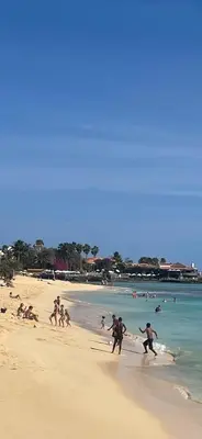 a group of people playing in the water on a beach at T-2 Santa Maria in Santa Maria