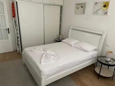a bedroom with a white bed with a white headboard at Holiday Sal Island in Santa Maria