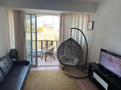 a living room with a couch and a swing at Holiday Sal Island in Santa Maria