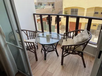 a glass table and chairs on a balcony at Holiday Sal Island in Santa Maria