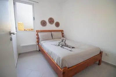 a bedroom with a bed with a stuffed animal on it at Modern Gateway in Santa Maria