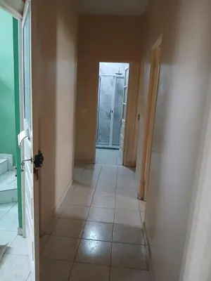 an empty hallway with a tile floor and a door at Mar&Cruz in Mindelo
