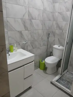 a white bathroom with a toilet and a sink at Mar&Cruz in Mindelo