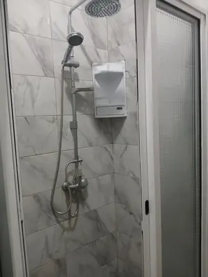 a shower with a shower head and a shower at Mar&Cruz in Mindelo