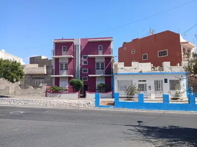 a row of buildings on the side of a street at Mar&Cruz in Mindelo