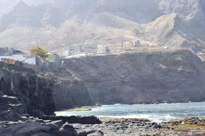 a city on a rocky mountain next to the ocean at Apartamento Fritzi in Ponta do Sol