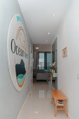 a living room with a welcome to ocean view sign on the wall at Santa Ocean View in Mindelo