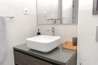 a bathroom with a white sink on a counter at Santa Ocean View in Mindelo
