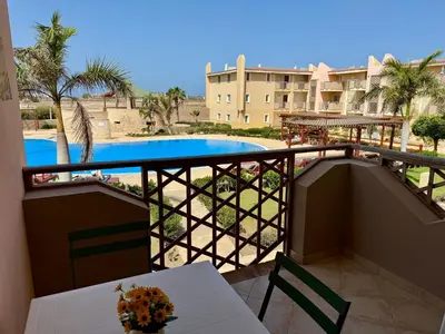a balcony with a table and a view of a pool at Tropical Mar Profundo in Santa Maria