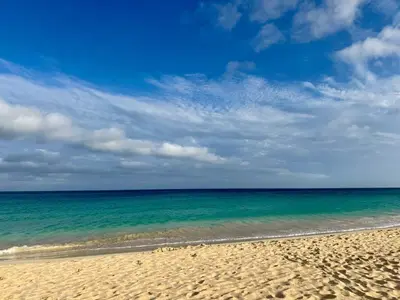 a beach with the ocean and a blue sky at Tropical Mar Profundo in Santa Maria