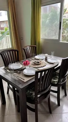 a wooden table with chairs and plates and glasses at Estrella Do Mar Santa Maria in Santa Maria