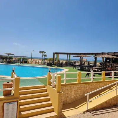 a resort with a swimming pool with tables and chairs at A1-5101- 3 Bedroom Seaview Apartment in Cape Verde in Sal Rei