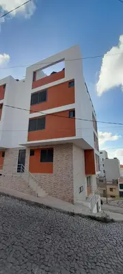 a building with orange and white on a street at Alto in Mindelo