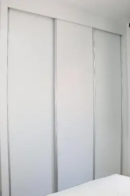 a row of four sliding doors in a room at Alto in Mindelo