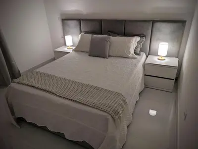 a bedroom with a large bed with two night stands at Modern and Stylish 1BR Apt - Cidadela - Ground Floor in Praia