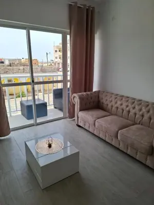 a living room with a couch and a table at Apartamentos Fatynybal in Espargos