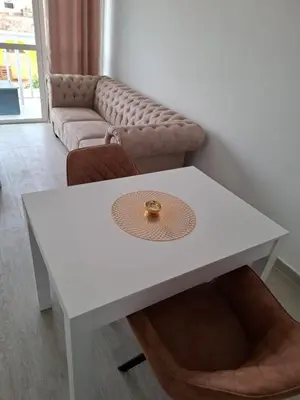 a white coffee table in a living room with a couch at Apartamentos Fatynybal in Espargos
