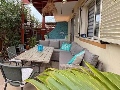 a patio with a couch and a table and chairs at Casa Paradise in Santa Maria