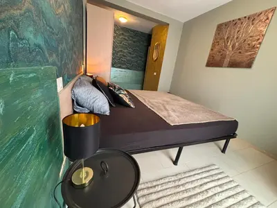 a small bedroom with a bed and a table at Casa Paradise in Santa Maria