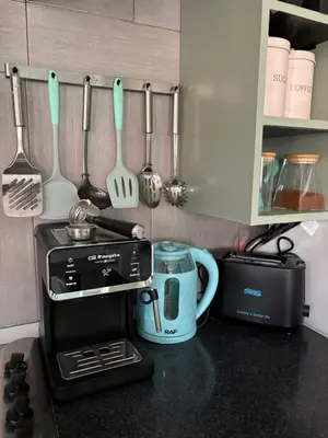 a kitchen counter with a coffee maker and a toaster at Casa Paradise in Santa Maria