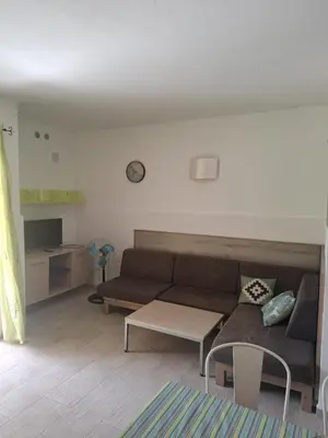 a living room with a couch and a table at Djadsal Moradias - Near the ocean in Santa Maria