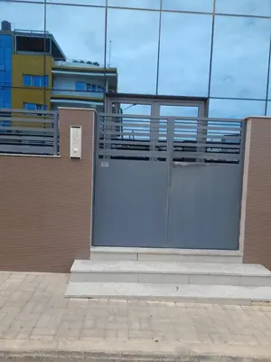 a glass building with a gate and stairs in front at Conforto in Praia