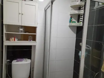 a white bathroom with a toilet and a shower at Conforto in Praia