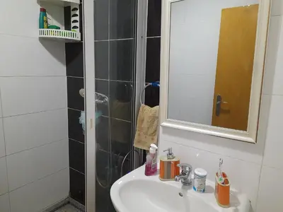 a bathroom with a sink and a shower at Conforto in Praia