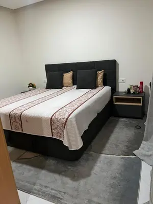 a bedroom with a large bed with a black headboard at Aconchego da Bety in Praia